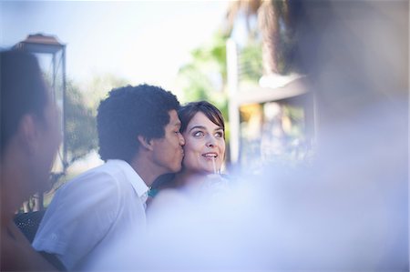 simsearch:614-06623977,k - Man kissing girlfriend at table outdoors Stock Photo - Premium Royalty-Free, Code: 614-06623996