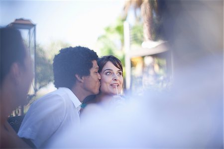 patio and wine - Man kissing girlfriend at table outdoors Stock Photo - Premium Royalty-Free, Code: 614-06623996