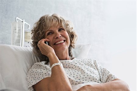 Female hospital patient using cellphone Stock Photo - Premium Royalty-Free, Code: 614-06718079