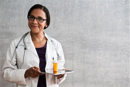 pharmaceutical tech - Female with digital tablet and medicine Stock Photo - Premium Royalty-Free, Code: 614-06718071