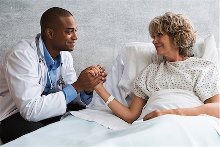 doctor comforting a patient - Doctor holding patient's hand Stock Photo - Premium Royalty-Free, Code: 614-06718073