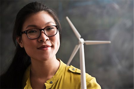 Woman with model wind turbine Stock Photo - Premium Royalty-Free, Code: 614-06718118