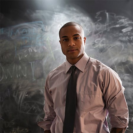 photography chalk board - Portrait of man in front of blackboard Stock Photo - Premium Royalty-Free, Code: 614-06718123