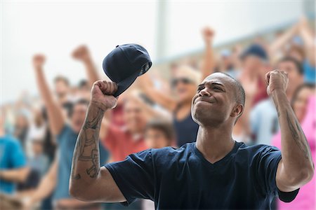 Man sports game, holding baseball cap and looking frustrated Stock Photo - Premium Royalty-Free, Code: 614-06718177