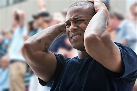 people in the stadium - Disappointed man at sports game Photographie de stock - Premium Libres de Droits, Code: 614-06718178