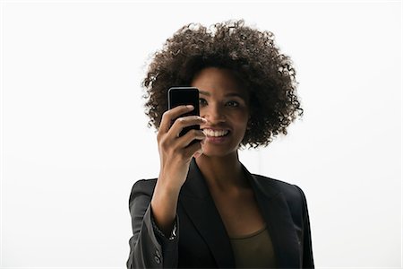 de una persona - Businesswoman photographing self on cameraphone Foto de stock - Sin royalties Premium, Código: 614-06718242