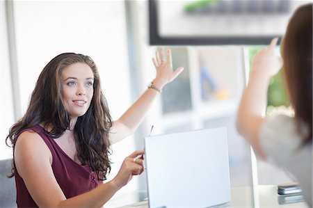 forecasting - Businesswomen pointing to graph Stock Photo - Premium Royalty-Free, Code: 614-06718291