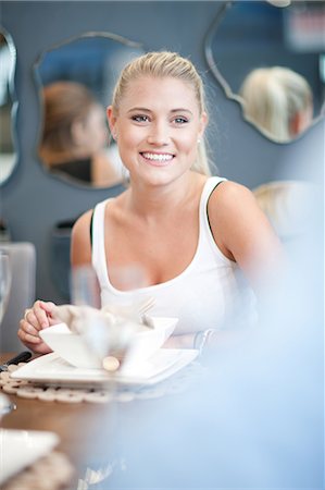 dine in interior - Woman smiling at dinner table Stock Photo - Premium Royalty-Free, Code: 614-06718391