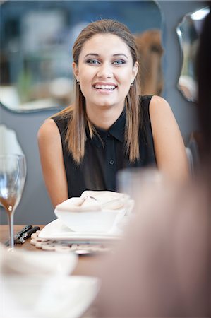 Woman laughing at dinner table Stock Photo - Premium Royalty-Free, Code: 614-06718392