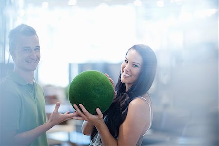 simsearch:614-06718375,k - Smiling couple holding green ball Stock Photo - Premium Royalty-Free, Code: 614-06718412