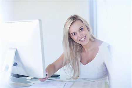 simsearch:614-06718619,k - Businesswoman smiling at desk Stock Photo - Premium Royalty-Free, Code: 614-06718628