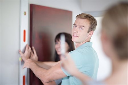 decorating a wall - Couple working with interior designer Stock Photo - Premium Royalty-Free, Code: 614-06718663