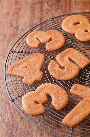 Cookies in number shapes on cooling rack Stock Photo - Premium Royalty-Free, Code: 614-06718732