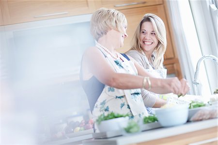 Mother and daughter cooking in kitchen Stock Photo - Premium Royalty-Free, Code: 614-06718802