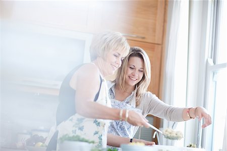 fifty years old blonde - Mother and daughter cooking in kitchen Stock Photo - Premium Royalty-Free, Code: 614-06718803