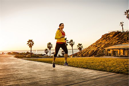 Woman running on wooden path Stock Photo - Premium Royalty-Free, Code: 614-06718834