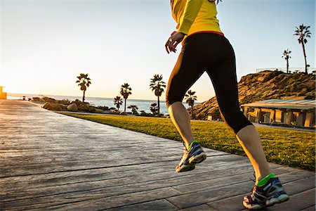 Woman running on wooden path Fotografie stock - Premium Royalty-Free, Codice: 614-06718832