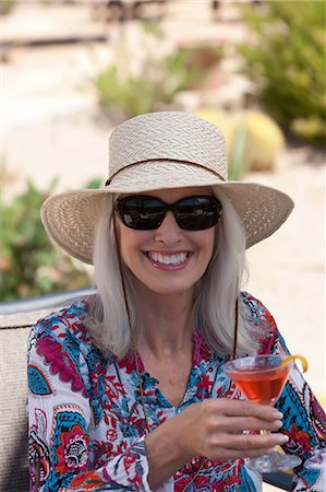 Active senior woman in sun hat hiking stock photo