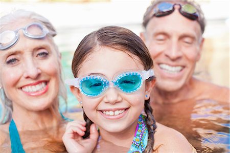 swimming pool with children - Girl and grandparents swimming in pool Photographie de stock - Premium Libres de Droits, Code: 614-06719042