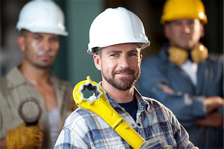 Industrial worker smiling in plant Stock Photo - Premium Royalty-Free, Code: 614-06719117