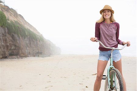 sunhat on beach - Woman on bicycle on beach Stock Photo - Premium Royalty-Free, Code: 614-06719158