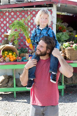 family portraits outside home - Father and son at farmer?s market Stock Photo - Premium Royalty-Free, Code: 614-06719225