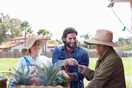 senior couple shopping outside - Couple shopping at farmer's market Stock Photo - Premium Royalty-Free, Code: 614-06719240