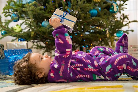 pyjamas (sleepwear with pants) - Toddler girl opening Christmas gifts Stock Photo - Premium Royalty-Free, Code: 614-06719305