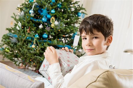 Boy opening Christmas gift Stock Photo - Premium Royalty-Free, Code: 614-06719327
