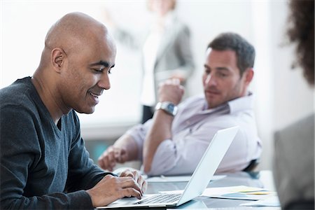 standing on a table - Businessman using laptop in meeting Stock Photo - Premium Royalty-Free, Code: 614-06719431