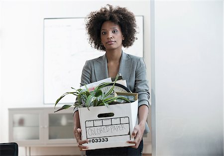 sad adult looking at camera - Businesswoman packing up box in office Stock Photo - Premium Royalty-Free, Code: 614-06719449