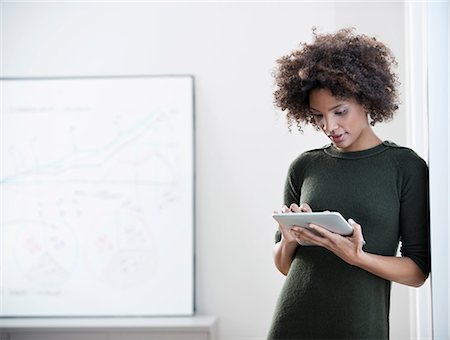 reading on a tablet - Businesswoman using tablet computer Stock Photo - Premium Royalty-Free, Code: 614-06719476