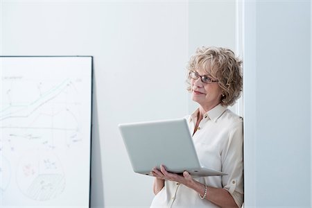 senior women blond short hair - Businesswoman using laptop in office Stock Photo - Premium Royalty-Free, Code: 614-06719470