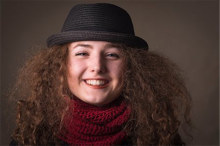 Smiling woman wearing hat and scarf Stock Photo - Premium Royalty-Free, Code: 614-06719554