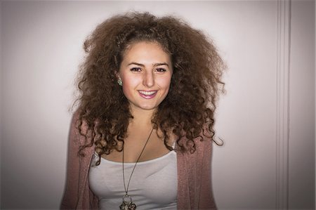 Smiling woman with curly hair Stock Photo - Premium Royalty-Free, Code: 614-06719593