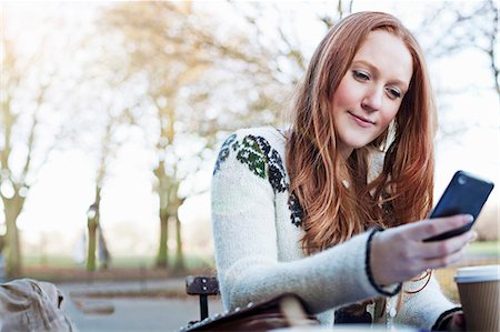 female holding a mobile phone - Woman using cell phone outdoors Stock Photo - Premium Royalty-Free, Code: 614-06719603