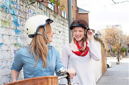 Women on bicycles on city street Stock Photo - Premium Royalty-Free, Code: 614-06719622