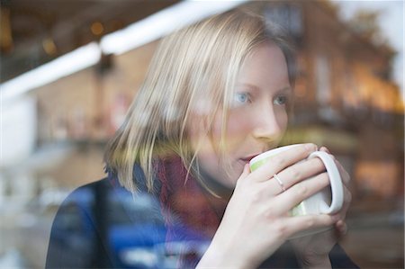 food by window - Woman drinking cup of coffee in cafe Stock Photo - Premium Royalty-Free, Code: 614-06719637
