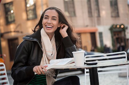 students laughing - Woman reading at sidewalk cafe Stock Photo - Premium Royalty-Free, Code: 614-06719697