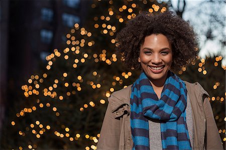 Woman smiling on city street Stock Photo - Premium Royalty-Free, Code: 614-06719715