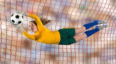 Soccer player catching ball in air Stock Photo - Premium Royalty-Free, Code: 614-06719866