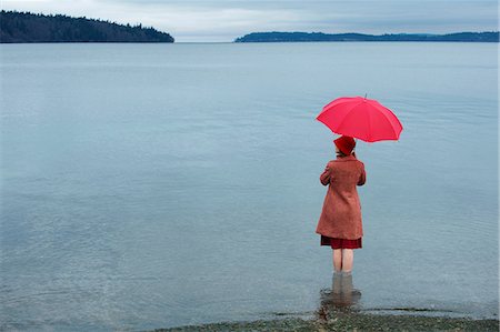 rainy days - Woman with umbrella in rural lake Stock Photo - Premium Royalty-Free, Code: 614-06719877