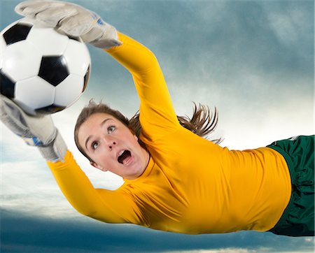 female goalies soccer - Soccer player catching ball in air Stock Photo - Premium Royalty-Free, Code: 614-06719871