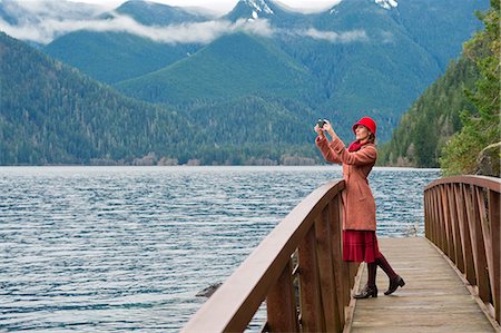 freedom not looking at camera horizontal - Woman taking picture on wooden bridge Stock Photo - Premium Royalty-Free, Code: 614-06719903