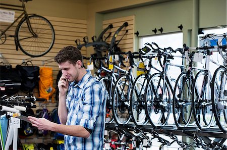 shop mobile - Man shopping in bicycle shop Stock Photo - Premium Royalty-Free, Code: 614-06719981