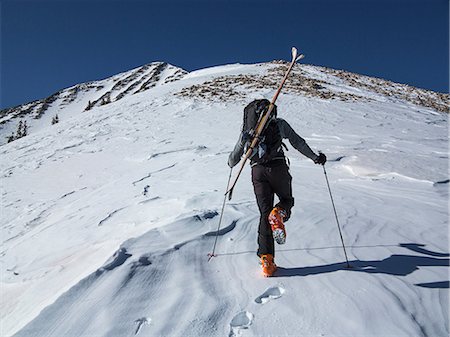 racchetta da sci - Cross country skier hiking up slope Fotografie stock - Premium Royalty-Free, Codice: 614-06720098