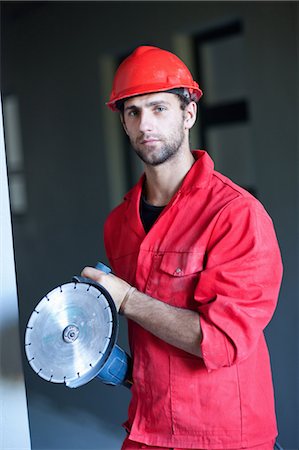 precision work - Portrait of building contractor with circular saw Stock Photo - Premium Royalty-Free, Code: 614-06814046