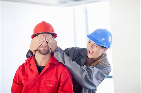 female hands covering eyes - Young couple fooling around on construction site Stock Photo - Premium Royalty-Free, Code: 614-06814042