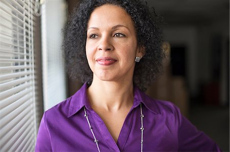 Mature woman looking out of window Stock Photo - Premium Royalty-Free, Code: 614-06814077