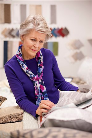 Senior woman choosing textile swatches Stock Photo - Premium Royalty-Free, Code: 614-06814089